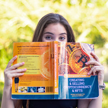 University of Miami student Zsa Zsa Goldstrom with the book about NFTs and cryptocurrencies that she co-authored