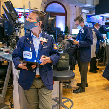 Traders work on the New York Stock Exchange floor in New York, Tuesday, Jan. 25, 2022. Stocks are closing lower on Wall Street Tuesday after another volatile day of trading. Technology companies like Microsoft were again the biggest drag on the market. (AP Photo/Ted Shaffrey)