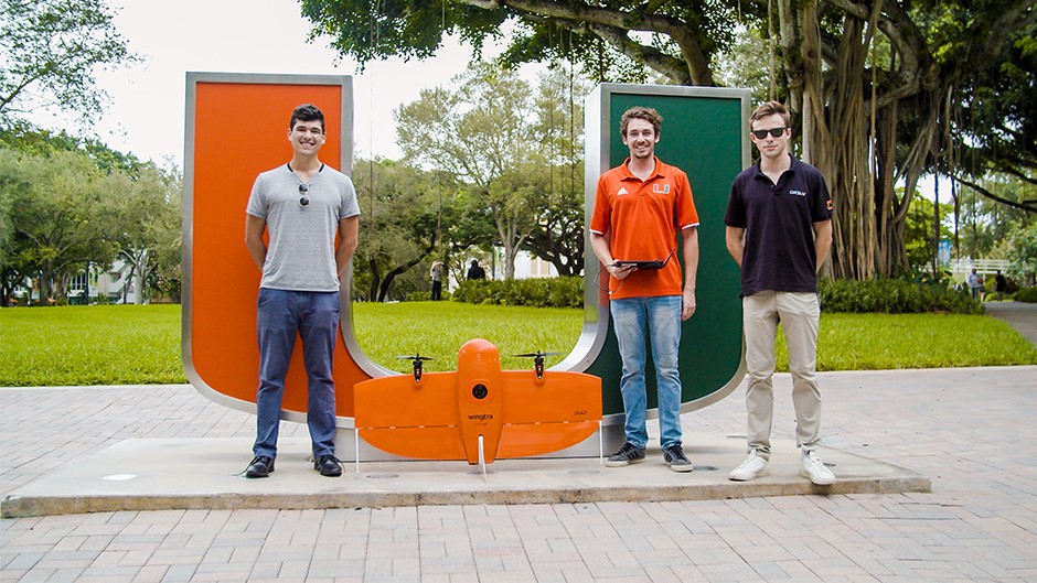 From left, Benjamin Kling, Alexander Leiva and Whitaker Redgate pose with Precision Ecology’s Wingtra drone. Photo: TJ Lievonen/University of Miami