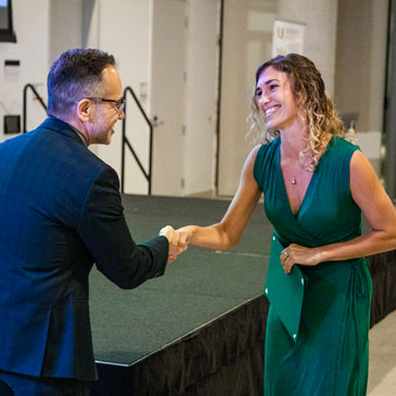 Guillermo Prado, dean of the Graduate School, congratulates first place winner Liv Williamson, a doctoral student in marine biology and ecology at the Rosenstiel School of Marine and Atmospheric Science. Photo: Diego Meza-Valdes/University of Miami