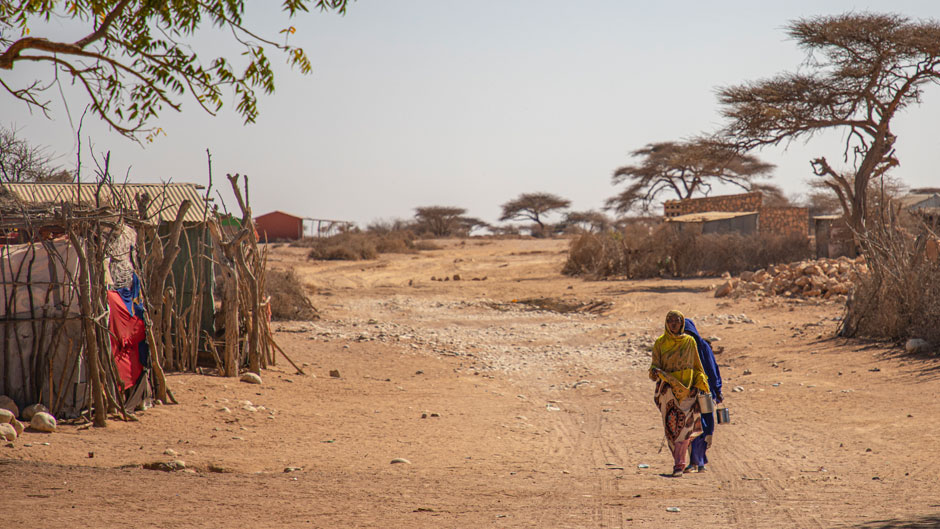 Women walk through the community of Ceel Dheere in Somaliland, a semi-autonomous region of Somalia, on March 14, 2022. An estimated 13 million people are facing severe hunger in the Horn of Africa as a result of persistent drought conditions, according to the United Nations. (Daniel Jukes/ActionAid via AP)