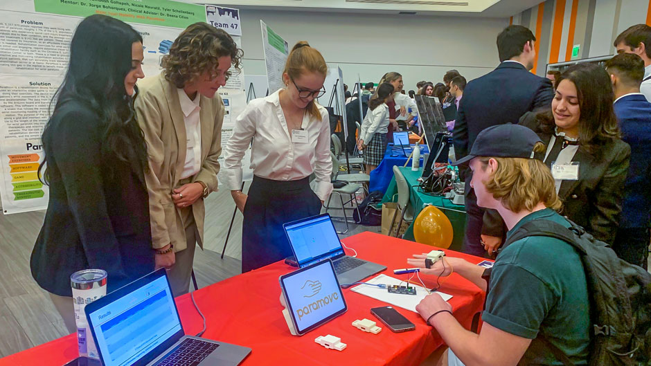 Engineering students test a new way to rehab wrist paralysis at the senior design expo. Photo: Robert C. Jones Jr./University of Miami