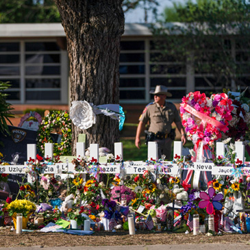 PHOTO: FILE - Flowers and candles are placed around crosses at a memorial outside Robb Elementary School to honor the victims killed in this week's school shooting in Uvalde, Texas Saturday, May 28, 2022. The gunmen in two of the nation's most recent mass shootings, including last week's massacre at the Texas elementary school, legally bought the assault weapons they used after they turned 18. That's prompting Congress and policymakers in even the reddest of states to revisit whether to raise the age limit to purchase such weapons. (AP Photo/Jae C. Hong, File)
