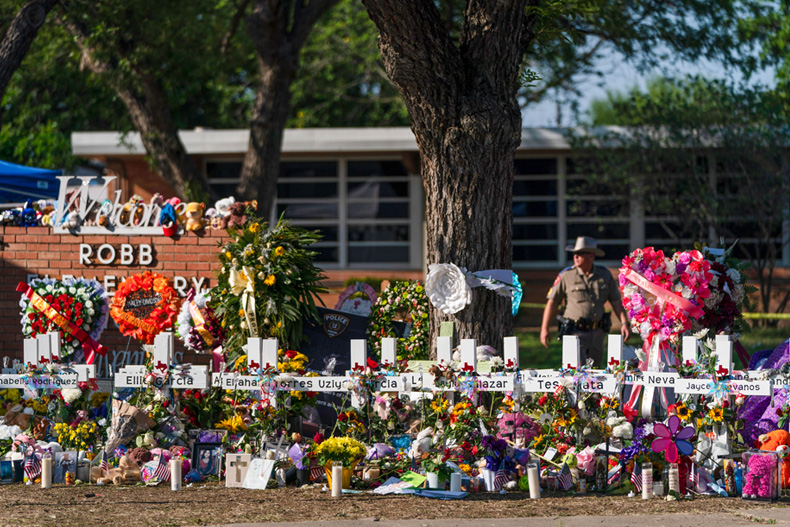 PHOTO: FILE - Flowers and candles are placed around crosses at a memorial outside Robb Elementary School to honor the victims killed in this week's school shooting in Uvalde, Texas Saturday, May 28, 2022. The gunmen in two of the nation's most recent mass shootings, including last week's massacre at the Texas elementary school, legally bought the assault weapons they used after they turned 18. That's prompting Congress and policymakers in even the reddest of states to revisit whether to raise the age limit to purchase such weapons. (AP Photo/Jae C. Hong, File)