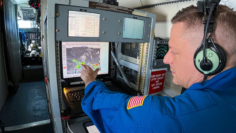 A flight director aboard the modified Gulfstream IV jet examines imagery of a potential tropical disturbance.