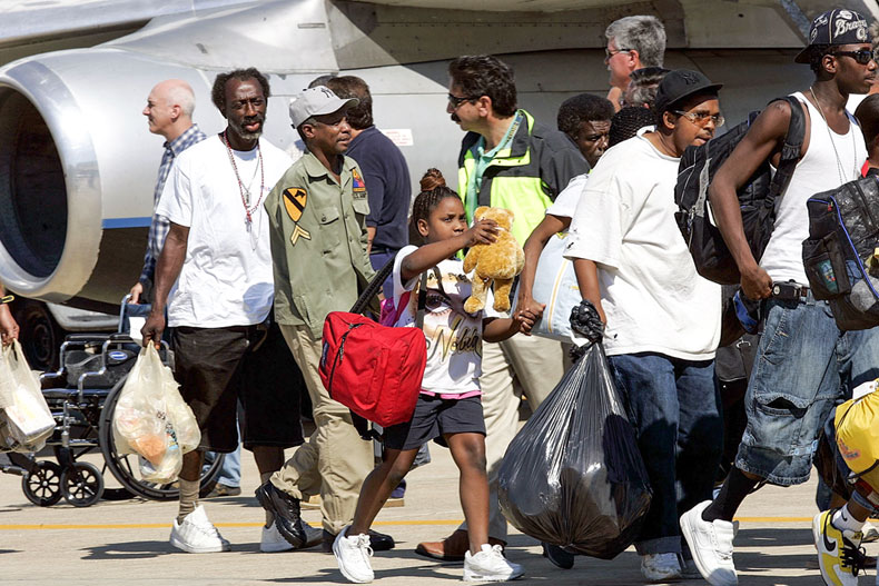 Evacuees of Hurricane Katrina arrived at Camp Edward on Cape Cod, Mass., Thursday, Sept. 8, 2005. A plane carrying more than 100 Hurricane Katrina refugees landed at the military base in Mass. (AP Photo/Chitose Suzuki)