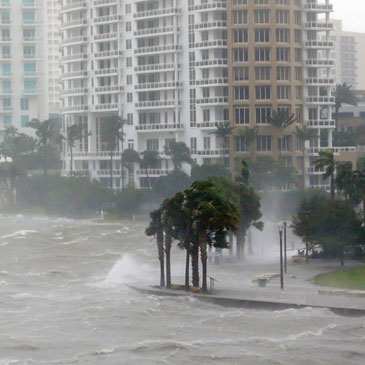 In this Sept. 10, 2017, photo, waves crash over a seawall at the mouth of the Miami River from Biscayne Bay, Fla., as Hurricane Irma passes by in Miami. Rising sea levels and fierce storms have failed to stop relentless population growth along U.S. coasts in recent years, a new Associated Press analysis shows. The latest punishing hurricanes scored bull’s-eyes on two of the country’s fastest growing regions: coastal Texas around Houston and resort areas of southwest Florida. (AP Photo/Wilfredo Lee)