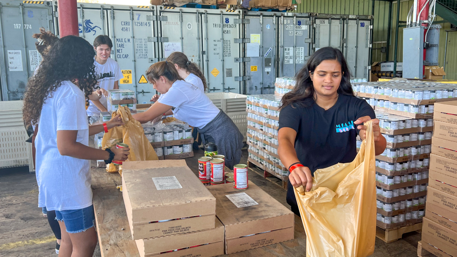 Students at Farm Share, a Florida-based nonprofit food bank, packaged and distributed canned goods for the community.