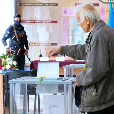 A man casts his ballot during a referendum in Luhansk, Luhansk People's Republic controlled by Russia-backed separatists, eastern Ukraine, Tuesday, Sept. 27, 2022. Voting began Friday in four Moscow-held regions of Ukraine on referendums to become part of Russia. (AP Photo) 