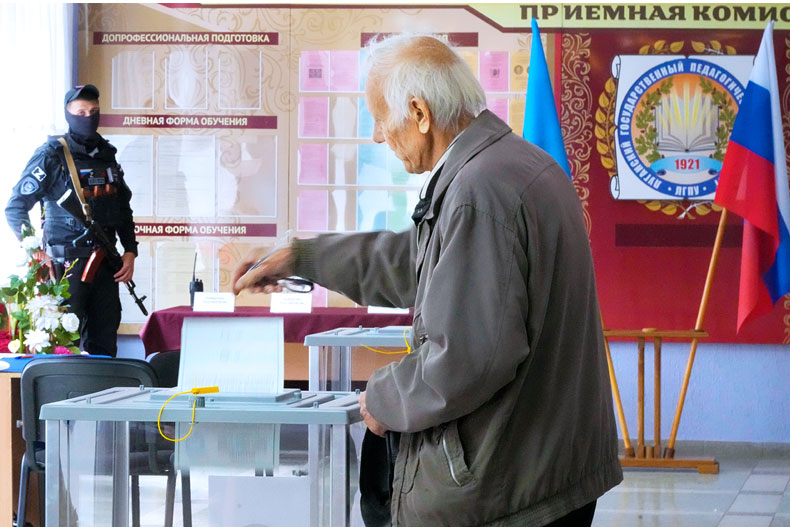 A man casts his ballot during a referendum in Luhansk, Luhansk People's Republic controlled by Russia-backed separatists, eastern Ukraine, Tuesday, Sept. 27, 2022. Voting began Friday in four Moscow-held regions of Ukraine on referendums to become part of Russia. (AP Photo) 