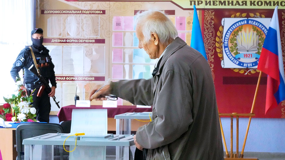 A man casts his ballot during a referendum in Luhansk, Luhansk People's Republic controlled by Russia-backed separatists, eastern Ukraine, Tuesday, Sept. 27, 2022. Voting began Friday in four Moscow-held regions of Ukraine on referendums to become part of Russia. (AP Photo)