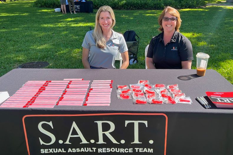 Volunteers at a table for the Sexual Assault Resource Team
