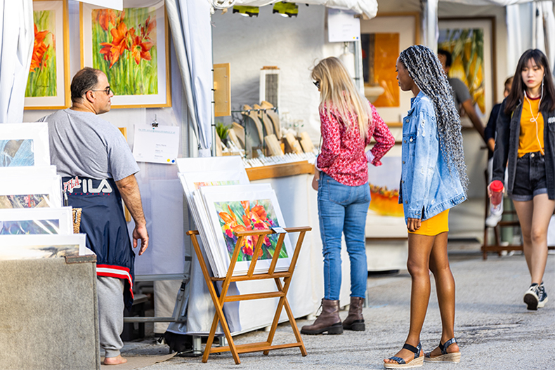 Festival attendees browse works of art at the Beaux Arts Festival of Art in 2020 on the Coral Gables Campus. 