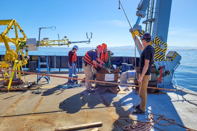 During a research expedition in Monterey Bay, scientists prepare to launch one of eight ASIS buoys that have collected data on coastal land, air and sea interactions. Photo courtesy of Brian Haus