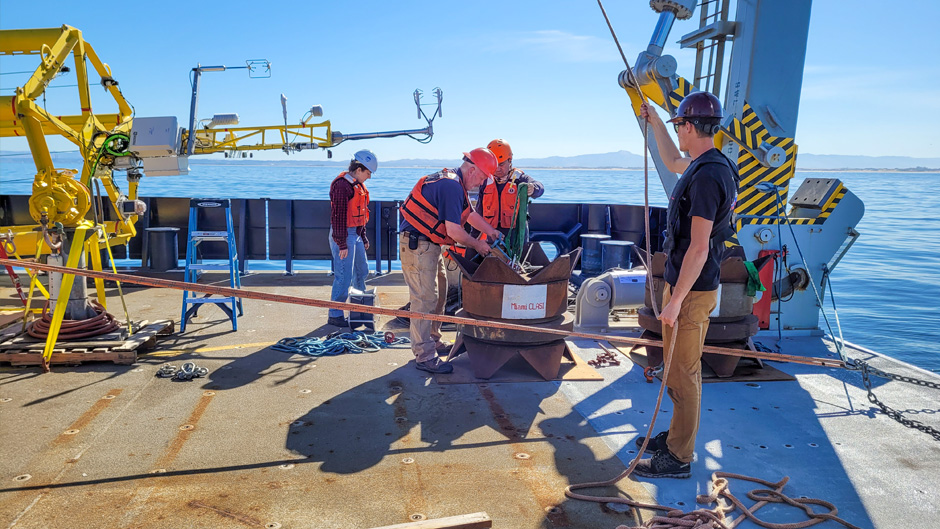 During a research expedition in Monterey Bay, scientists prepare to launch one of eight ASIS buoys that have collected data on coastal land, air and sea interactions. Photo courtesy of Brian Haus