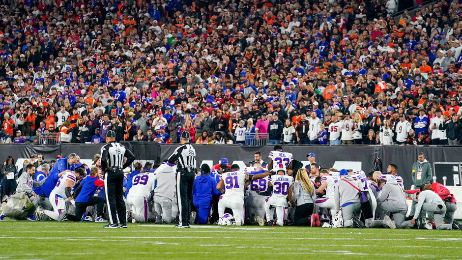 Buffalo Bills players kneel after teammate Damar Hamlin is injured during the first half of an NFL football game against the Cincinnati Bengals, Monday, Jan. 2, 2023, in Cincinnati. (AP Photo/Jeff Dean)