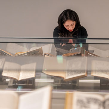 Valeria Salgado, a library technician, checks out some of the items on display on the second floor of the Kislak Collection on Tuesday afternoon. Photo: Joshua Prezant/University of Miami