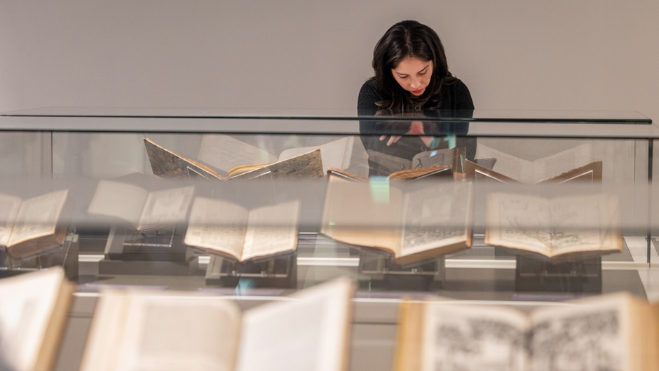 Valeria Salgado, a library technician, checks out some of the items on display on the second floor of the Kislak Collection on Tuesday afternoon. Photo: Joshua Prezant/University of Miami
