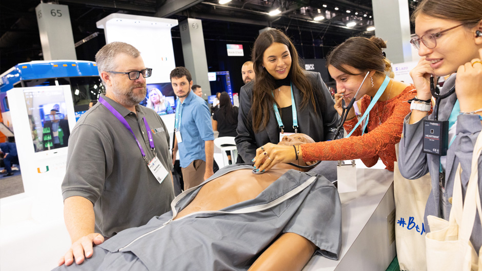 As Dr. Ross J. Scalese, left, looks on, Miami Beach Senior High School students, from left, Samantha Martin, Christina Hope-Borges, and Kim Sartor, engage with Harvey Manikin, a full-size cardiopulmonary simulator developed by the University of Miami’s Gordon Center for Research and Medical Education. Photo: Joshua Prezant/University of Miami