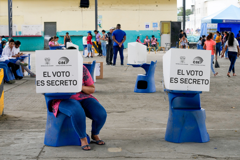 A voter marks her ballot during the snap election, in Guayaquil, Ecuador, Sunday, Aug. 20, 2023. The election was called after President Guillermo Lasso dissolved the National Assembly by decree in May to avoid being impeached. (AP Photo/Martin Mejia)