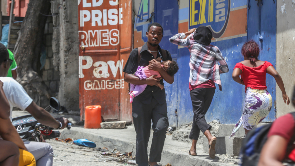 Residents flee their homes to escape clashes between armed gangs in the Carrefour-Feuilles district of Port-au-Prince, Haiti, Tuesday, Aug. 15, 2023. (AP Photo/Odelyn Joseph)