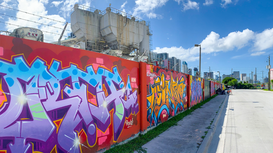 Overtown murals with a cement plant in background.