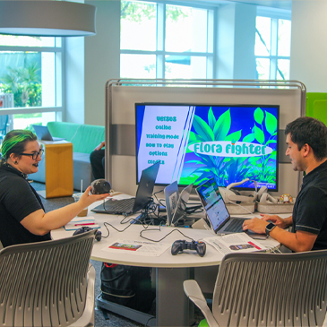 Students in the interactive media program at the School of Communication discuss a video game that one created last spring. Photo: Abbie Bernet/University of Miami. 