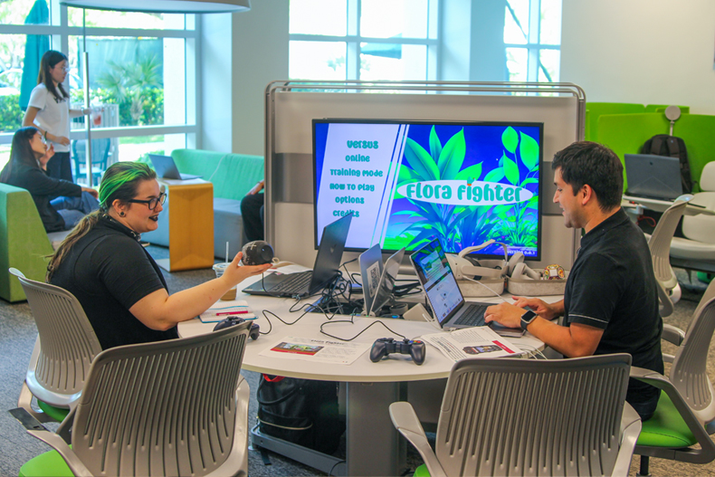 Students in the interactive media program at the School of Communication discuss a video game that one created last spring. Photo: Abbie Bernet/University of Miami. 