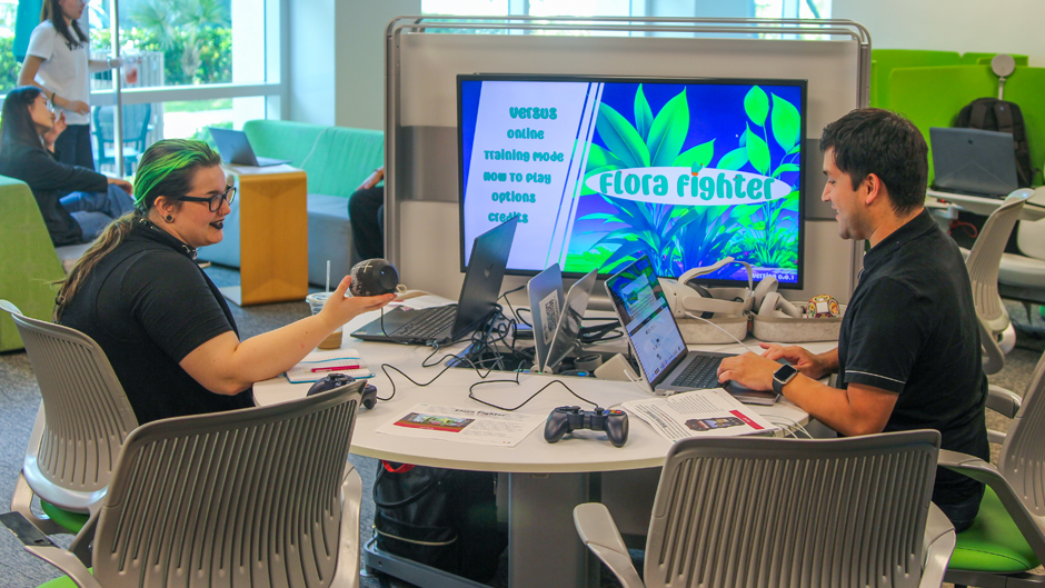 Students in the interactive media program at the School of Communication discuss a video game that one created last spring. Photo: Abbie Bernet/University of Miami.