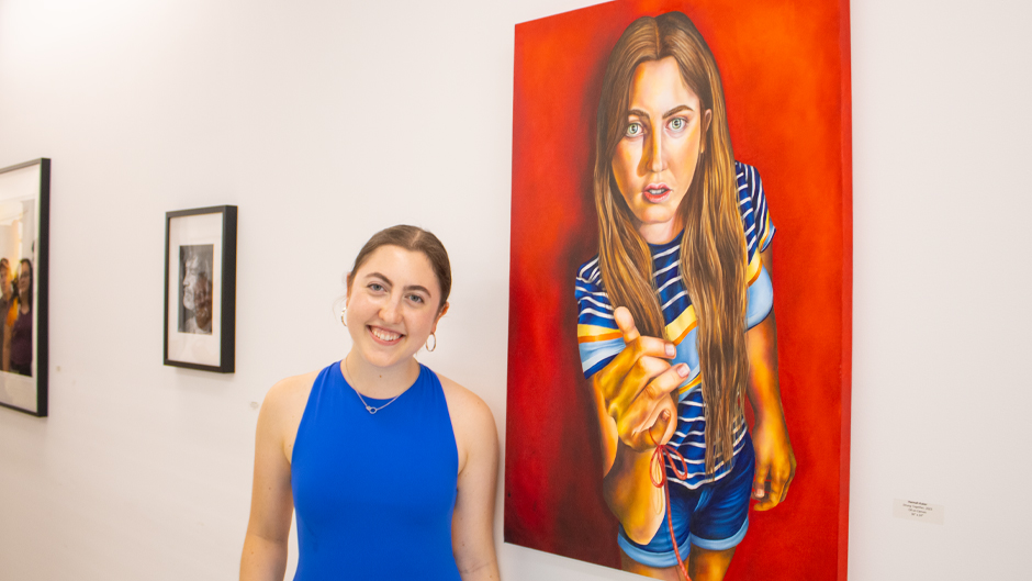 Hannah Kuker with her canvas. Photo: Bianca Sproul for University of Miami