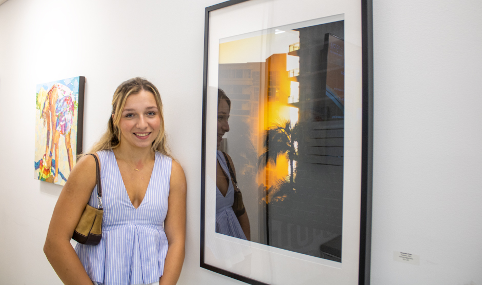 Alexandra Fisher poses next to her digital print, “Haulover.” Photo: Bianca Sproul for University of Miami