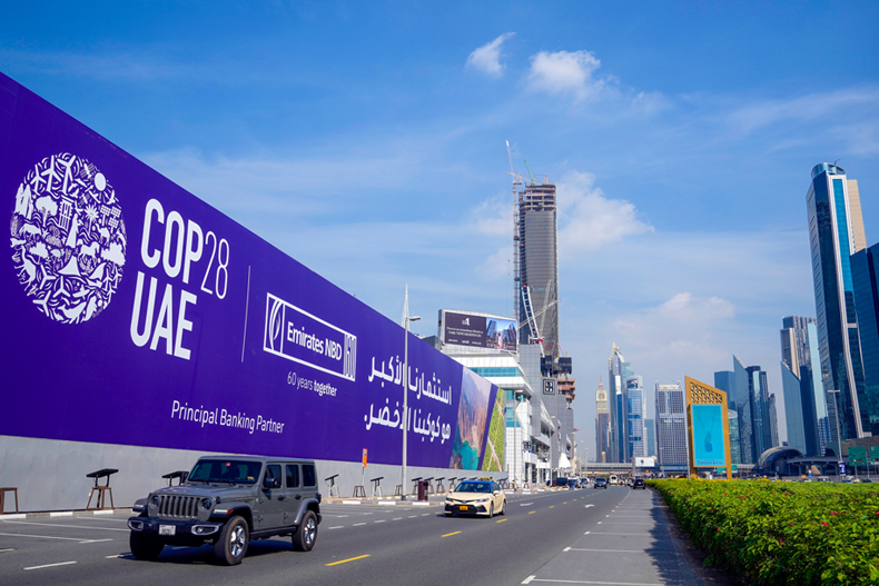 Cars pass by a billboard advertising COP28 at Sheikh Zayed highway in Dubai, United Arab Emirates, Monday, Nov. 27, 2023. Representatives will gather at Expo City in Dubai, UAE, Nov. 30 to Dec. 12 for the 28th U.N. Climate Change Conference, known as COP28. (AP Photo/Kamran Jebreili) 