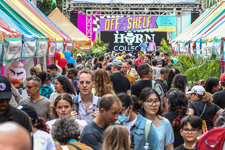 Visitors explore the street fair at the 2022 Miami Book Fair in Downtown Miami.