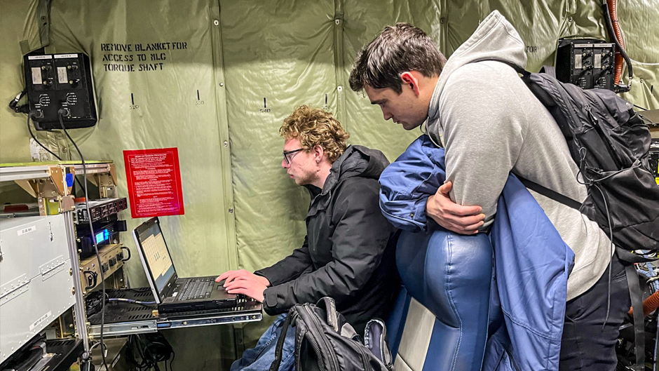 Rosenstiel School graduate students Sam Ephraim, seated, and Tyler Tatro examine data collected from instruments aboard the C-130. 
