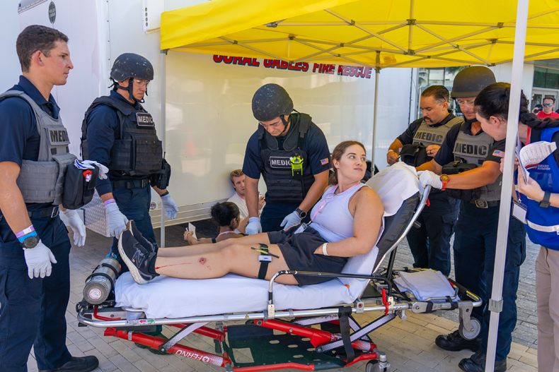 EXERCISE — Coral Gables Fire Rescue prepares to transport a role-player during a full-scale emergency training exercise held at Stanford Residential College on Wednesday, May 22, 2024.