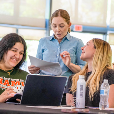 Professor Katlyn Meier reviews Chemistry 102 exam questions with a group of students during the Finish Strong study event held at Lakeside Village.