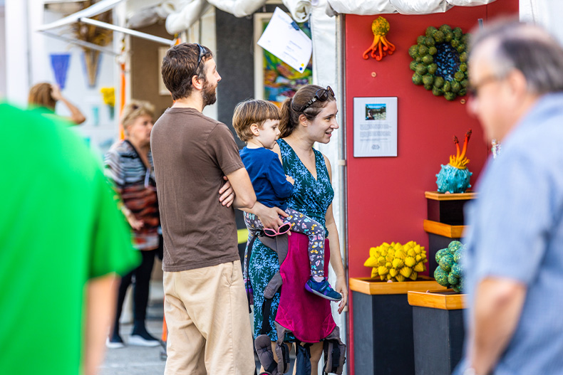 Festival attendees browse works of art at the Beaux Arts Festival of Art on the Coral Gables Campus.