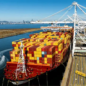 Cargo containers line a ship at the Port of Oakland on Wednesday, Aug. 6, 2025, in Oakland, Calif.  