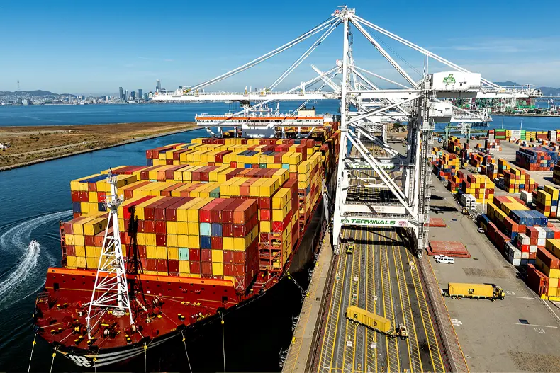 Cargo containers line a ship at the Port of Oakland on Wednesday, Aug. 6, 2025, in Oakland, Calif.  