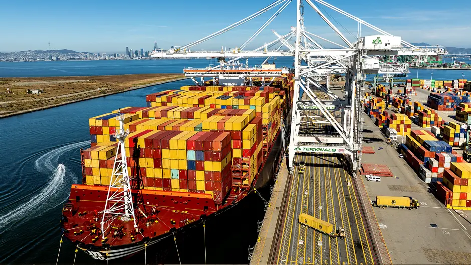 Cargo containers line a ship at the Port of Oakland on Wednesday, Aug. 6, 2025, in Oakland, Calif. 