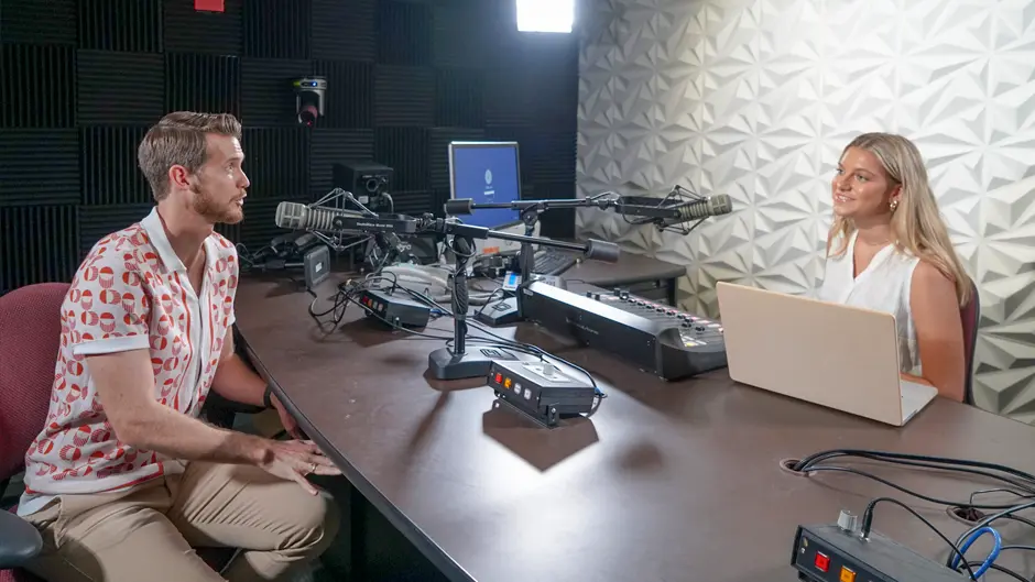 Students record a podcast episode.