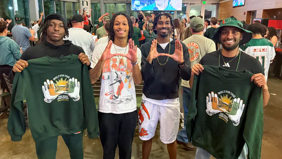 Four friends celebrate the Canes