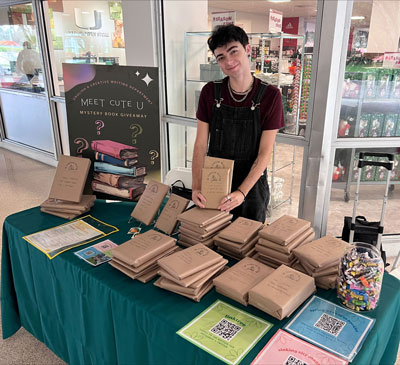 Third year MFA student Allen Means organized a “Meet Cute with a Book,” a book giveaway aimed at undergraduate students and a chance for them to learn more about Creative Writing opportunities on campus.