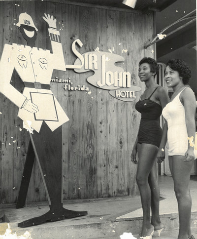 Two women in front of the Sir John Hotel