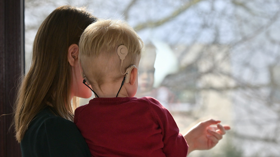 Child with cochlear implant and mother