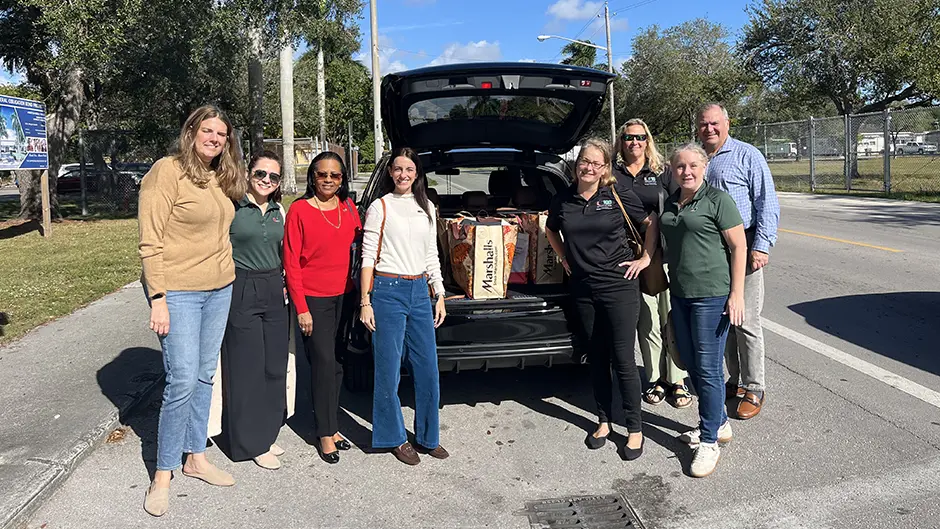 Dean Leonidas Bachas and members of his office staff dropping off donations