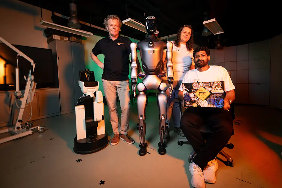 Members of the robotics team with two of their robots