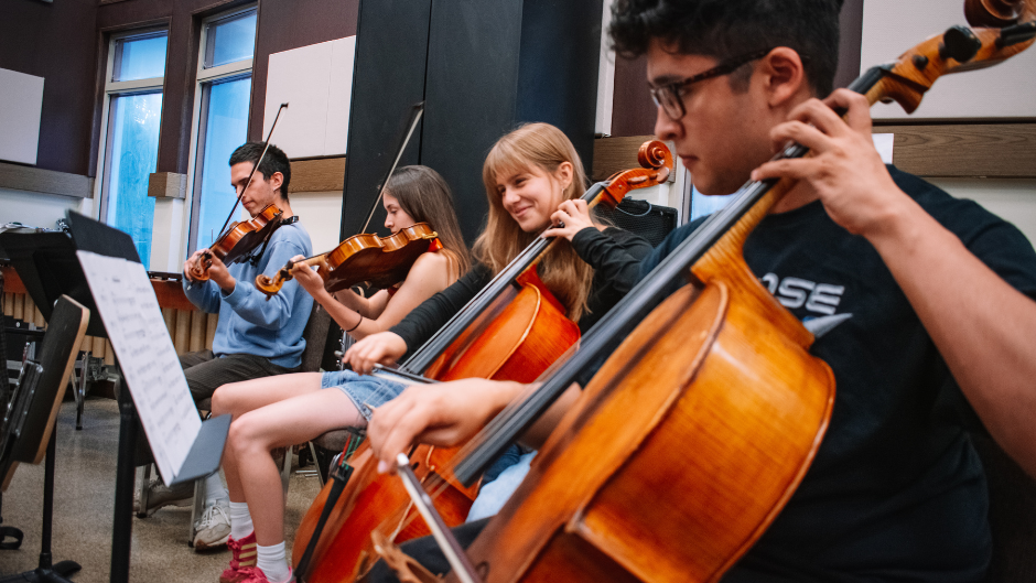  Student musicians in the Rock Symphonic orchestra rehearsing.