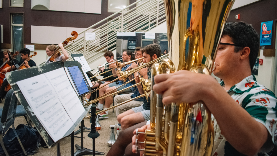 Student musicians in the Rock Symphonic orchestra rehearsing.