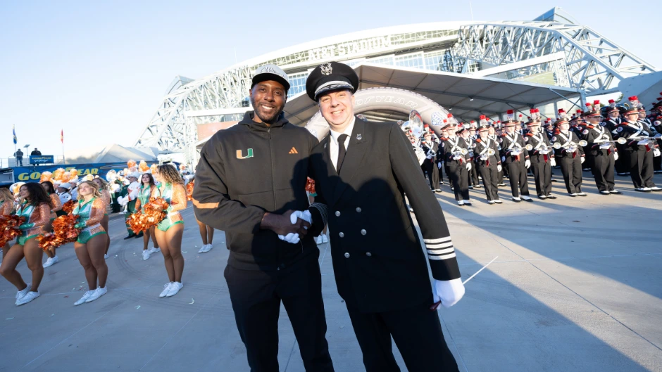 Associate athletic band director Sheldon McLean with Christopher Hoch, director of the Ohio State University marching band, before the Cotton Bowl. Photo by Joshua Prezant/University of Miami.
